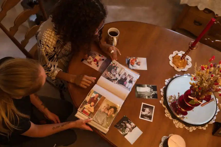 Family members looking through photo albums together at a table