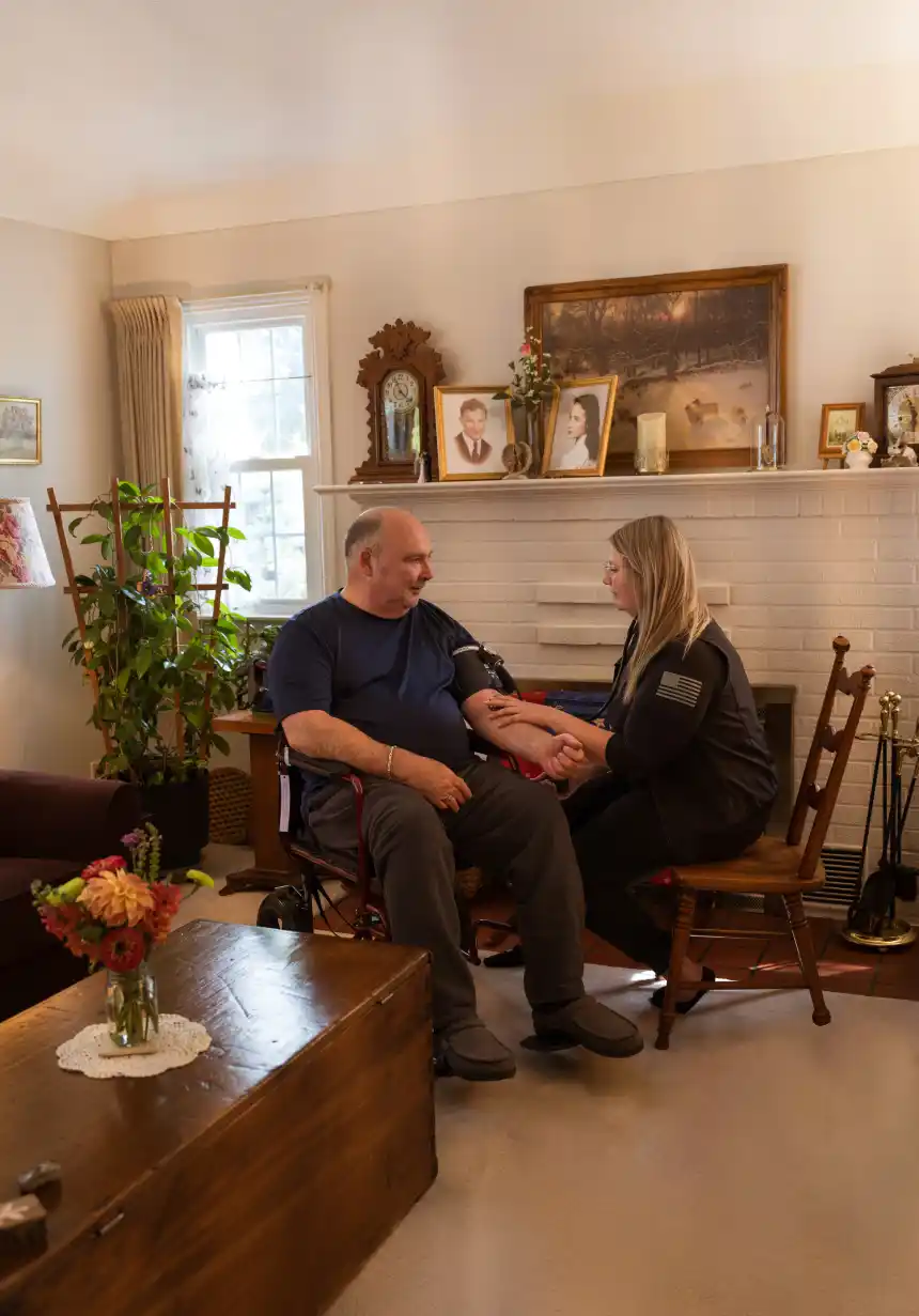 Hospice nurse checking a patient’s blood pressure in his home