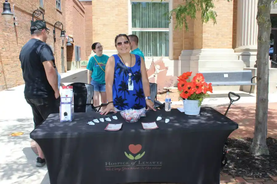 Hospice of Lenawee staff member welcoming visitors at a community outreach event